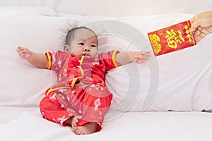 Asian baby boy Chinese Cheongsam costume toddler lie down on bed at home smiling laughing good humored  infant Chinese boy laugh