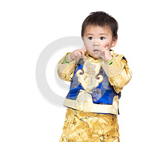 Asian baby boy with chinese costume and finger point to face