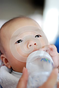Asian baby is drinking milk