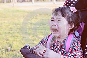 Asian baby girl crying in stroller outdoor