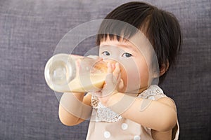 Asian baby girl feed with milk bottle