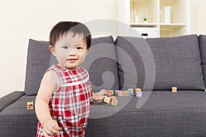 Asian baby girl play with wooden block