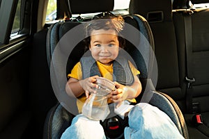 Asian Baby Girl Seated in Safe Toddler Seat In Auto