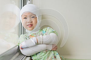 Asian baby girl are sick with Atopic dermatitis, She was wrapped with a bandage on the head neck arms and legs