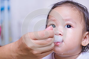 Asian baby girl sick he take medicine by spoon