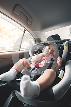 Asian baby girl sitting in car seat chair, Her have smile with happy time. Travel safely concept