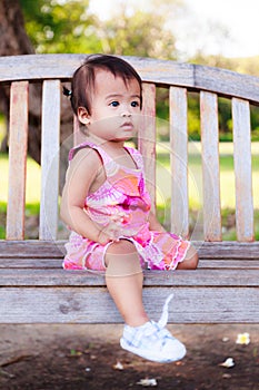 Asian baby girl sitting and looking forward