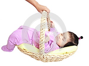 Asian baby girl sleeping in the basket
