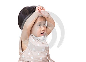 Asian baby girl touching her head