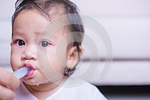 Asian Baby sick he take medicine by syringe with mother at home