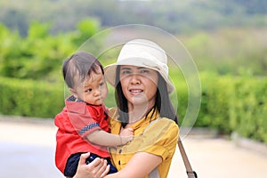 Asian baby travels with his mother on holiday