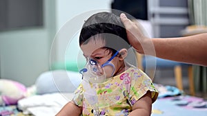 Asian baby was sick as respiratory syncytial virus rsv in kid hospital. Thai little girl having inhaler containing medicine