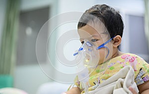 Asian baby was sick as Respiratory Syncytial Virus RSV in kid hospital. Thai little girl having inhaler containing medicine