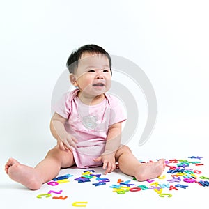 Asian baby with wooden alphabets