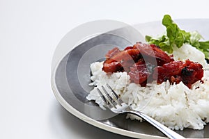 Asian barbecue pork on a bed of steamed rice.