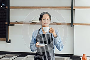 Asian barista women smelling coffee
