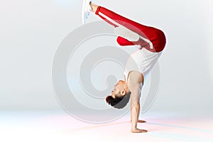 Asian Bboy standing in freeze stunt upside down balancing in air with legs photo