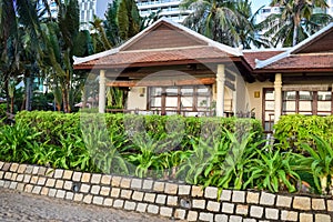 Asian beachfront buildings for tourists with green plants in the tropics