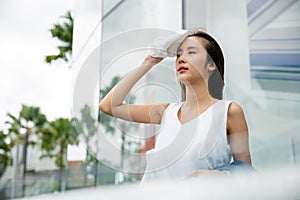 Asian beautiful business woman drying sweat her face with cloth in warm summer day hot weather