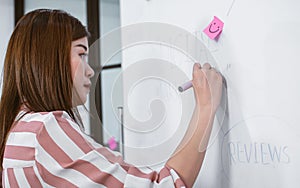 Asian beautiful business working woman wearing casual shirt, writing on white board her creative idea about project, marketing,