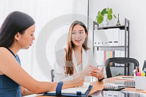 Asian beautiful empower woman smiling and talking with friend working at meeting room in office interior background with copy