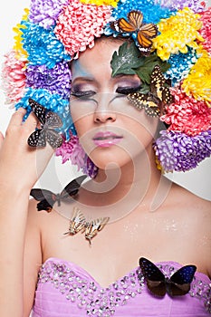 Asian Beautiful Girl With colorful make up with fresh Chrysanthemum Flowers and Butterfly