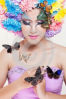 Asian Beautiful Girl With colorful make up with fresh Chrysanthemum Flowers and Butterfly