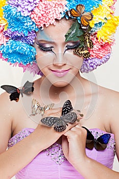 Asian Beautiful Girl With colorful make up with fresh Chrysanthemum Flowers and Butterfly