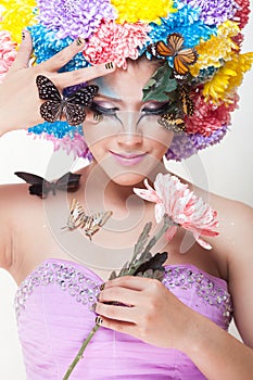 Asian Beautiful Girl With colorful make up with fresh Chrysanthemum Flowers and Butterfly