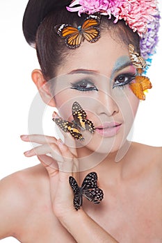 Asian Beautiful Girl With colorful make up with fresh Flowers and Butterfly