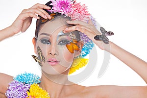 Asian Beautiful Girl With colorful make up with fresh Flowers and Butterfly