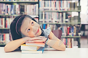 Asian beautiful girl reading books for education and go to school in library.