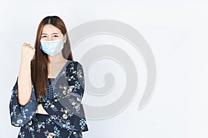 Asian beautiful happy hipster woman wearing a medical protection face mask for protect the coronavirus, filter dust PM 2.5 and