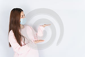 Asian beautiful happy hipster woman wearing a medical protection face mask for protect the coronavirus, filter dust PM 2.5 and