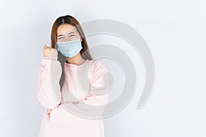 Asian beautiful happy hipster woman wearing a medical protection face mask for protect the coronavirus, filter dust PM 2.5 and