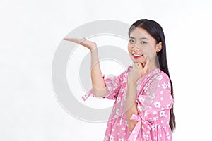 Asian beautiful woman with black long hair in white shirt shows thumb up and present something on white background