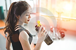 Asian beautiful woman drinking protein shake or drinking water i