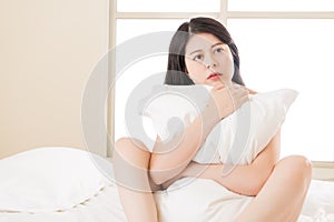 Asian beautiful woman feel unwell sickness sit on bed