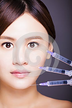 asian beautiful woman gets injection in her face. aesthetic medicine concept.