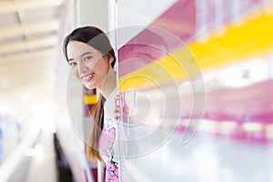 Asian beautiful woman say hello to her family due to working in the city by train or she arrive say welcome to home at the station