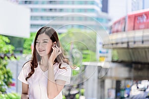 Asian beautiful woman tourist has music listening with headphone