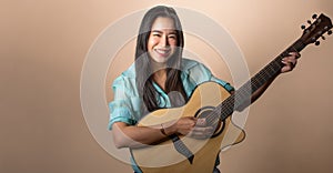 Asian beautiful woman wearing casual clothes, playing guitar, smiling with fun, happiness, standing on isolated background with