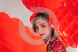 Asian beautiful woman wearing traditional cheongsam qipao dress take photography with group of red chinese lanterns