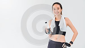 Asian beautiful women holding water bottle after play yoga and exercise on white wall background with copy space.Exercise for Lose