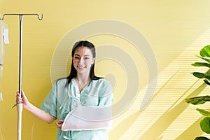 Asian beautiful women patients standing on yellow background,Happy and smiling,Good attitude,Copy space for text