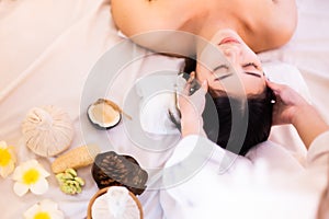 Asian Beautiful, young and healthy woman in spa salon. Massage treatment spa room  . Traditional medicine and healing concept
