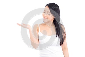 Asian beautiful young woman showing with healthy clean skin presenting something empty copy space on the hand isolated