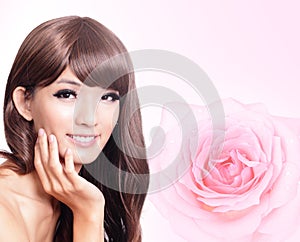 Asian beauty hand touch face with pink rose