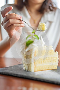 Asian beauty Scooping the cake to eat In Caffe Holiday idea Eating sweets, the cause of obesity, weight gain, poor health