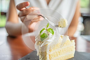 Asian beauty Scooping the cake to eat In Caffe Holiday idea Eating sweets, the cause of obesity, weight gain, poor health